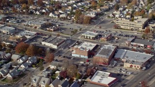 AX120_034 - 5.5K aerial stock footage of stores along a busy street in Autumn, Franklin Square, New York