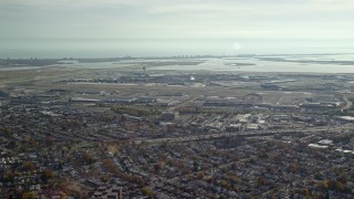 AX120_048 - 5.5K aerial stock footage of approaching John F. Kennedy International Airport in Autumn, Queens, New York