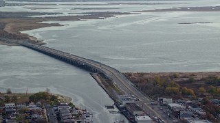 5.5K aerial stock footage of a small bridge spanning a bay in Autumn, Jamaica, New York Aerial Stock Footage | AX120_072E