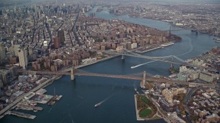 5.5K aerial stock footage of a view of the Brooklyn and Manhattan Bridges in Autumn, New York City Aerial Stock Footage | AX120_094