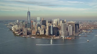 AX120_121E - 5.5K aerial stock footage of approach Lower Manhattan and Battery Park in Autumn, New York City