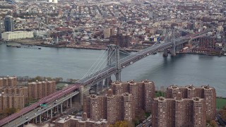 AX120_151E - 5.5K aerial stock footage approach the Williamsburg Bridge in Autumn, New York City