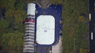 AX120_183E - 5.5K aerial stock footage of a bird's eye of ice skating rink at Bryant Park, Midtown, New York City