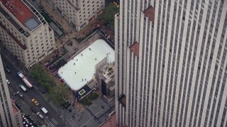 AX120_186E - 5.5K aerial stock footage orbit ice rink at Rockefeller Center, Midtown, New York City