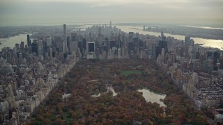 AX120_213E - 5.5K aerial stock footage approach Midtown from Central Park in Autumn, New York City