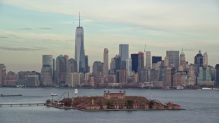 AX120_259E - 5.5K aerial stock footage orbit Ellis Island and Lower Manhattan skyline in Autumn, New York City