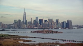 AX120_263E - 5.5K aerial stock footage of Lower Manhattan skyline and Ellis Island in Autumn, New York City