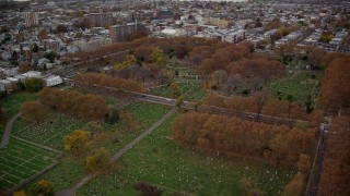 5.5K aerial stock footage approach a Jersey City cemetery by a freeway in Autumn, New Jersey Aerial Stock Footage | AX120_265E