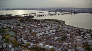 5.5K aerial stock footage of suburban homes and row houses near bridges in Autumn, Jersey City, New Jersey Aerial Stock Footage | AX120_269E