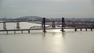 AX120_271E - 5.5K aerial stock footage orbit bridges spanning Newark Bay in Autumn, New Jersey