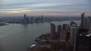 AX121_034E - 5.5K aerial stock footage fly around skyscraper to reveal Downtown Jersey City from Lower Manhattan at twilight