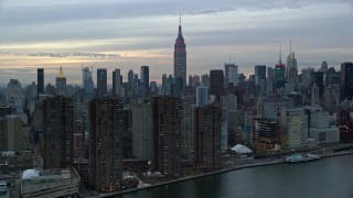 5.5K aerial stock footage of riverfront Midtown high-rises and Empire State Building at twilight in New York City Aerial Stock Footage | AX121_048E