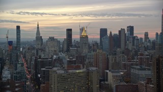 5.5K aerial stock footage of skyscrapers near Empire State Building at twilight in New York City Aerial Stock Footage | AX121_075