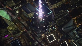 AX121_175 - 5.5K aerial stock footage approach top spire of Freedom Tower and tilt to bird's eye view at Night in NYC