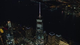 AX121_179E - 5.5K aerial stock footage of approaching top of Freedom Tower at Night in New York City