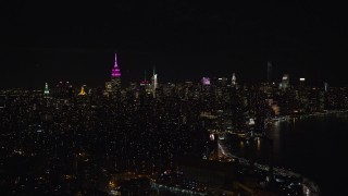 5.5K aerial stock footage of Midtown Manhattan seen from the shore of the East River at Night, NYC Aerial Stock Footage | AX122_070E