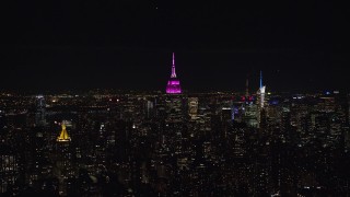 5.5K aerial stock footage orbit Empire State Building with pink light at Nighttime, Midtown, New York City Aerial Stock Footage | AX122_078E