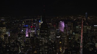 5.5K aerial stock footage orbit Empire State Building with the roof in darkness at Nighttime in Midtown, NYC Aerial Stock Footage | AX122_082E