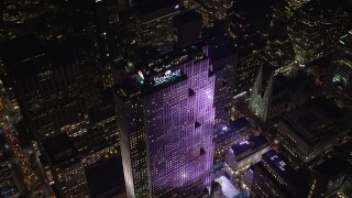 AX122_122E - 5.5K aerial stock footage approach Rockefeller Center at Night in Midtown Manhattan, New York City