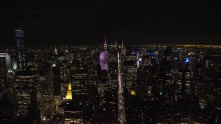 AX122_133E - 5.5K aerial stock footage orbit Midtown skyscrapers at Night in New York City