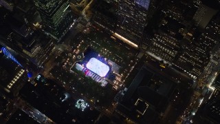 AX122_196 - 5.5K aerial stock footage of a bird's eye of ice rink at Bryant Park at Night in Midtown, New York City