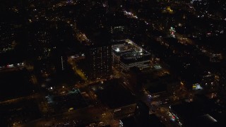 AX122_240 - 5.5K aerial stock footage orbit high school and apartment building on Lower East Side at Night, New York City