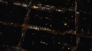 5.5K aerial stock footage of a bird's eye of Kenmare Street and stores at Night in Soho, New York City Aerial Stock Footage | AX122_245