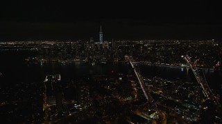 5.5K aerial stock footage fly over Brooklyn to approach bridges over East River and Lower Manhattan at Night, NYC Aerial Stock Footage | AX122_275E