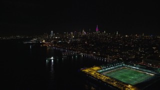 5.5K aerial stock footage of Midtown skyscrapers seen from Pier 40 in Greenwich Village at Night, New York City Aerial Stock Footage | AX122_289E