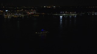 5.5K aerial stock footage of tracking a small boat on the Hudson River at Night, Union City, New Jersey Aerial Stock Footage | AX123_001