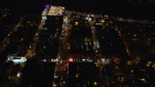 AX123_026 - 5.5K aerial stock footage fly over Harlem streets and apartment buildings at Night in NYC