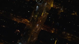 AX123_041 - 5.5K aerial stock footage of a bird's eye view of a bus on a Harlem Street at Night in New York City