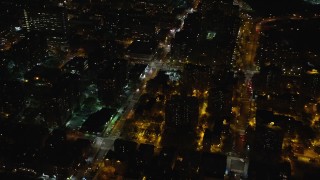 AX123_042 - 5.5K aerial stock footage approach an intersection in Harlem at Night in NYC