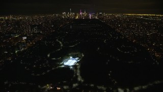 AX123_050E - 5.5K aerial stock footage fly over Central Park toward Midtown at Night in New York City