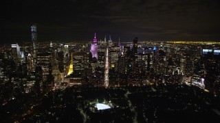 AX123_056E - 5.5K aerial stock footage approach Midtown at Night from Central Park in NYC