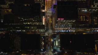 AX123_060E - 5.5K aerial stock footage of a bird's eye of 6th Avenue in Midtown at Night in New York City