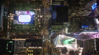 AX123_063E - 5.5K aerial stock footage of a bird's eye view of 6th Avenue in Midtown at Nighttime in New York City