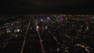 5.5K aerial stock footage of approaching skyscrapers of Midtown at Nighttime in NYC Aerial Stock Footage | AX123_074E