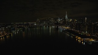 5.5K aerial stock footage approach Manhattan Bridge and Lower Manhattan skyline at Night in New York City Aerial Stock Footage | AX123_101E