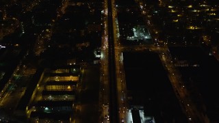 AX123_127 - 5.5K aerial stock footage of a bird's eye of an elevated train and Atlantic Avenue in Brooklyn at Night, New York City