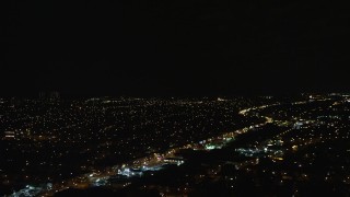 AX123_148E - 5.5K aerial stock footage of a wide view of suburban neighborhoods at Night in Queens Village, NYC