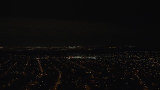 5.5K aerial stock footage of suburban neighborhoods and a bridge in the distance at Night in Queens, New York City Aerial Stock Footage | AX123_150E