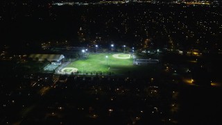 5.5K aerial stock footage of flying over suburban homes toward baseball fields at Night in Hempstead, New York Aerial Stock Footage | AX123_157E