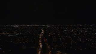 5.5K aerial stock footage pan across suburban neighborhoods and a strip mall at Night in Wantagh, New York Aerial Stock Footage | AX123_175E