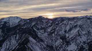 5.5K aerial stock footage of the sunrise over snowy winter Wasatch Range mountains in Utah Aerial Stock Footage | AX124_039