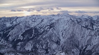 5.5K aerial stock footage of sunrise over snowy mountains of the Wasatch Range in Utah Aerial Stock Footage | AX124_050