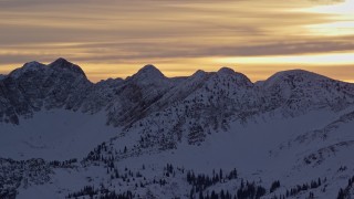 5.5K aerial stock footage of snowy mountain peaks in the Wasatch Range at sunrise, Utah Aerial Stock Footage | AX124_055E