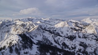 5.5K aerial stock footage of Wasatch Range mountains with winter snow at sunrise in Utah Aerial Stock Footage | AX124_126E