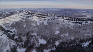 5.5K aerial stock footage of approaching a snowy ridge at sunrise in the Wasatch Range of Utah Aerial Stock Footage | AX124_135