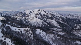 5.5K aerial stock footage of tall Wasatch Range snow mountains at sunrise in Utah Aerial Stock Footage | AX124_145